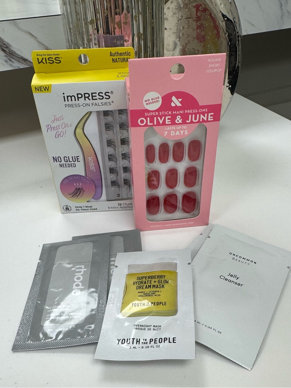 Olive & June Red Press-On Nails 
Impress Lashes and skincare samples.